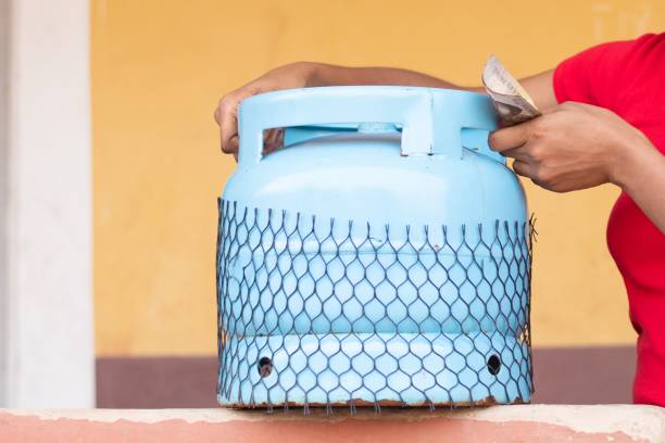 woman holding money and lifting a gas cylinder